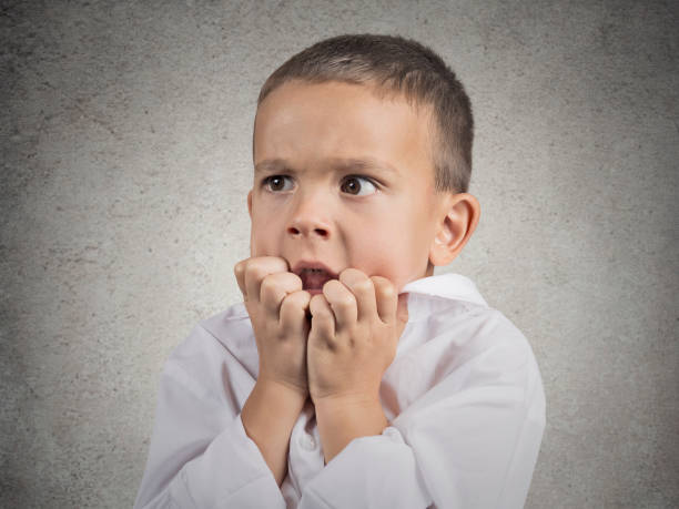 istock Closeup portrait nervous anxious stressed child boy biting fingernails 662267534