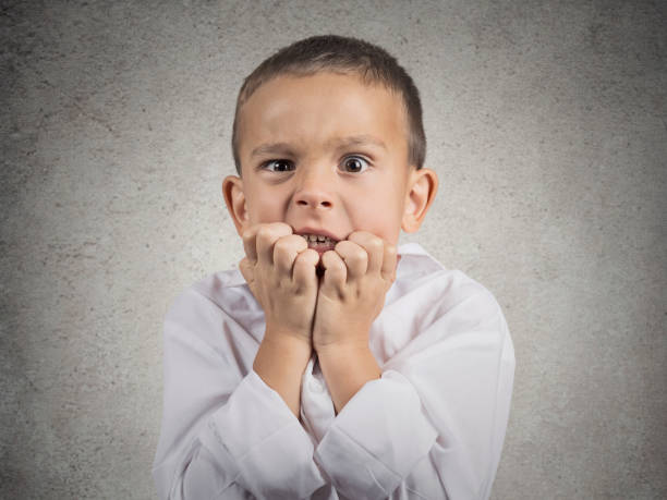 istock Closeup portrait nervous anxious stressed child boy biting fingernails 662267646