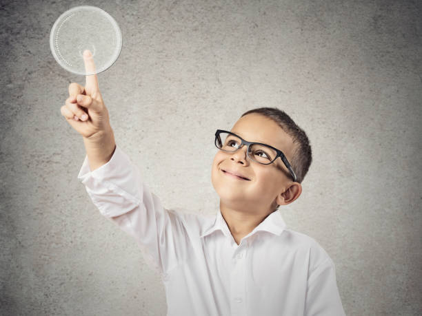 istock Closeup portrait happy boy with glasses pushing digital button 662269020