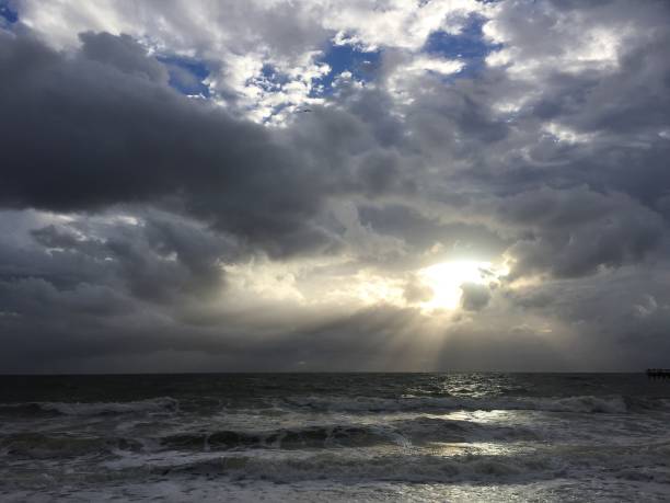 istock Sunrise behind the cloud on the beach 662322484