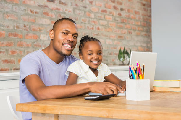 istock Cute daughter using laptop at desk with father 662372202