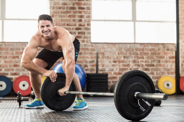 istock Muscular man set up his barbell weight 662402382