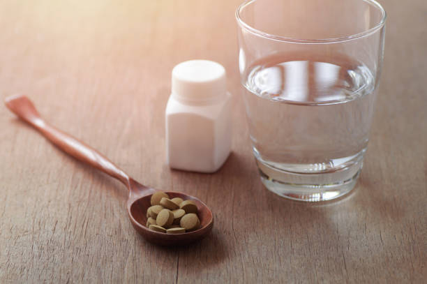 istock herb medicine in pill on wood table 662446098