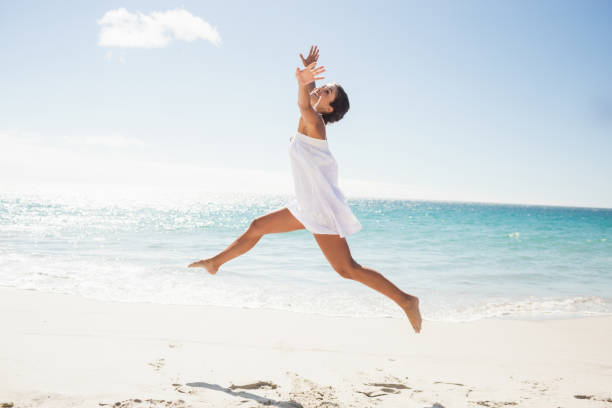 istock Happy woman relaxing at the beach 662478258