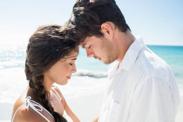 istock Happy couple embracing on the beach 662485636
