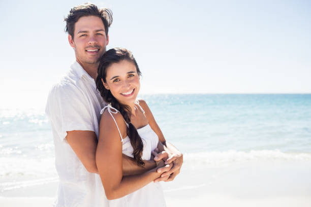 istock Happy couple embracing on the beach 662500676