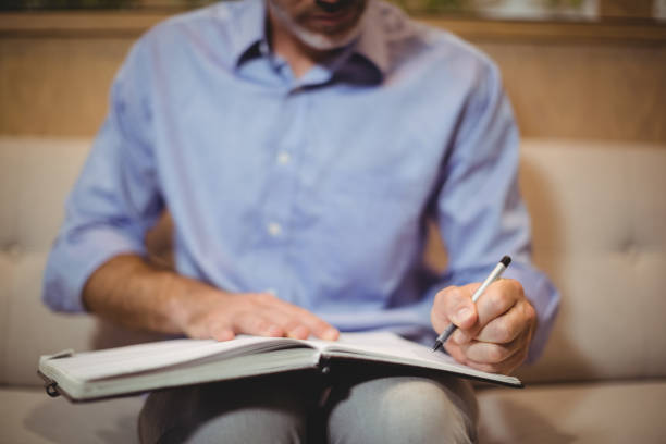 istock Mid section of doctor writing in organizer 662510208