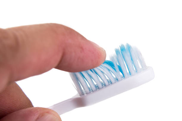 istock Finger touching soft and slim tapered toothbrush bristle 662520252