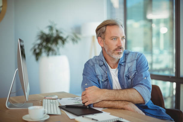 istock Thoughtful graphic designer sitting at desk 662533396
