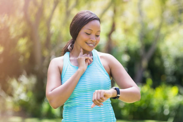 istock Happy woman posing and looking her watch 662553756