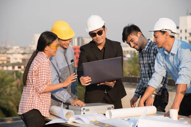 istock Group of engineers and architects discuss at a construction site 662565564