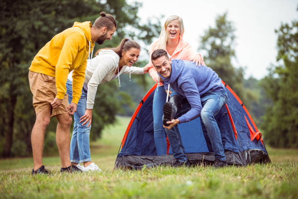istock Happy friends setting up their tent 662570194