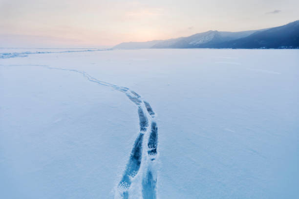 istock footprints in Baikal lake ice. Winter landscape 662586586