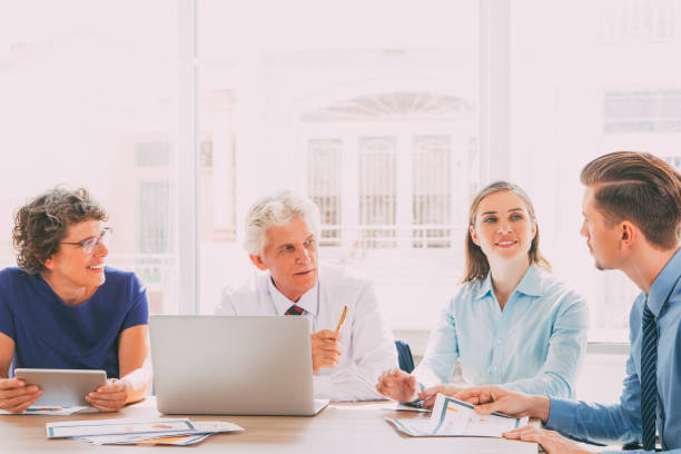 istock Group of four people discussing business issues_tone 662607594
