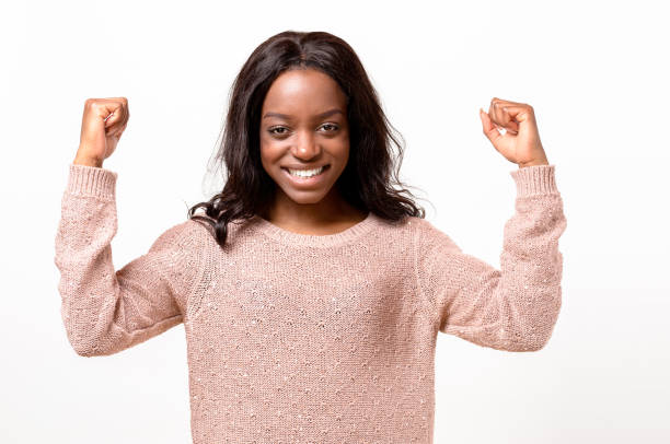 istock Exuberant young African woman cheering 662621910