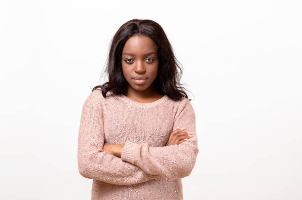 istock Serious young woman standing with folded arms 662624082