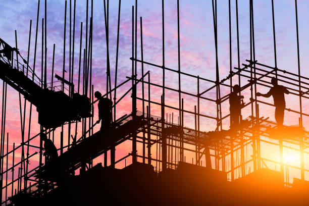 construction worker on construction site construction worker on construction site at sunset estate worker stock pictures, royalty-free photos & images