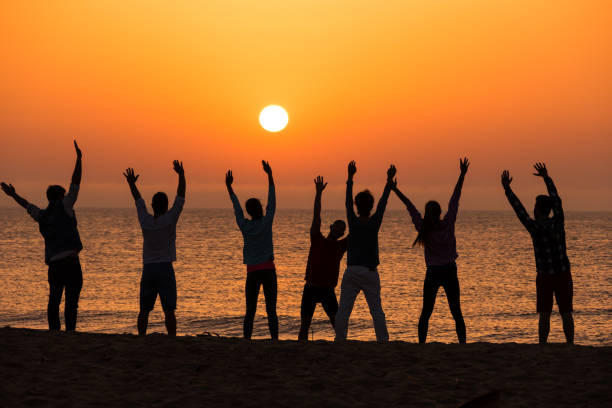 istock Group of people excercising on beach 662743800