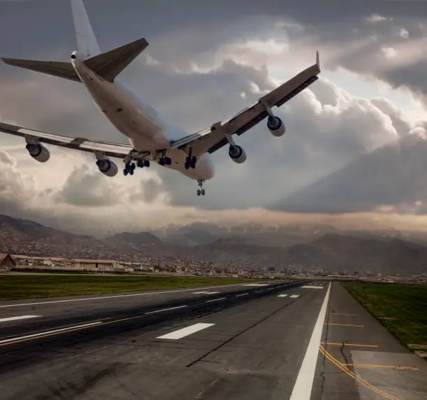 Photo of Jumbo Jet airplane landing at dusk