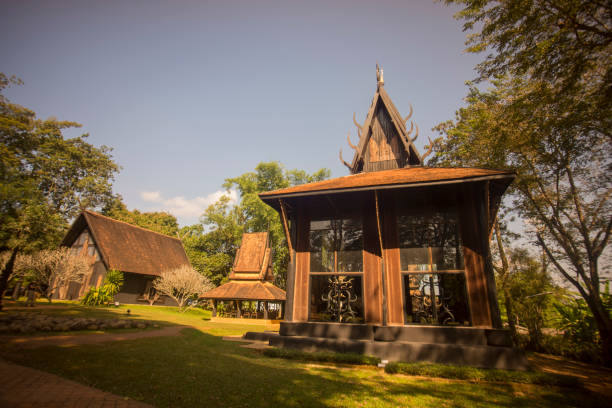 Two Thai massage therapists doing a massage for two female clients.