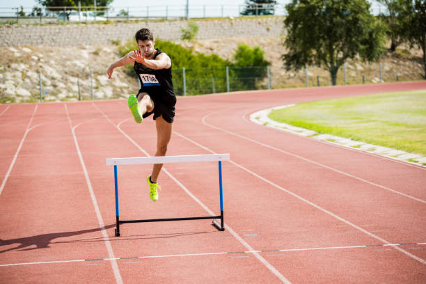 istock Athlete jumping above the hurdle 662863170