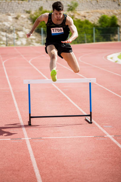 istock Athlete jumping above the hurdle 662866198