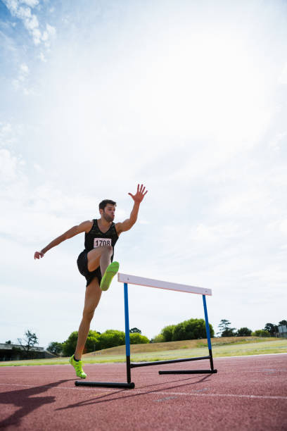 istock Athlete jumping above the hurdle 662870566