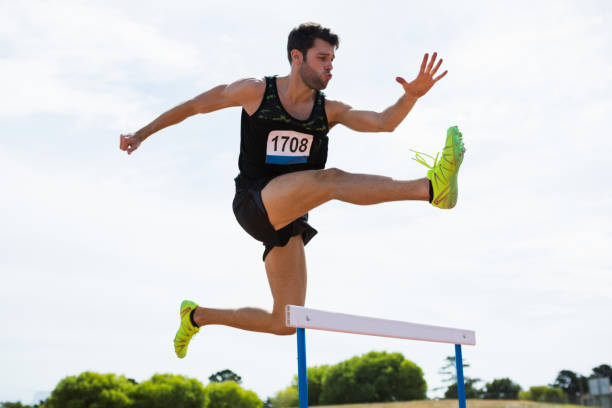 istock Athlete jumping above the hurdle 662870948