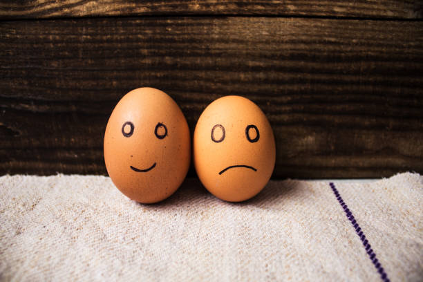 istock eggs with emotions on wooden background 662882466