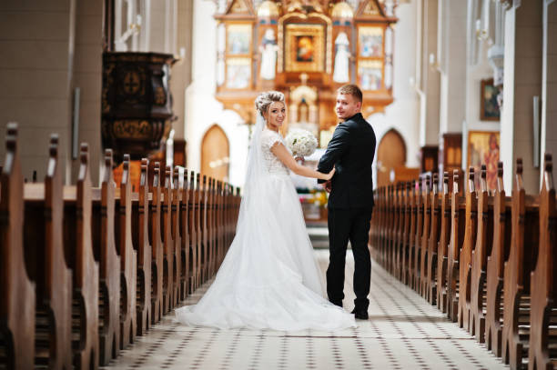 istock Wedding couple at catholic church 662882606