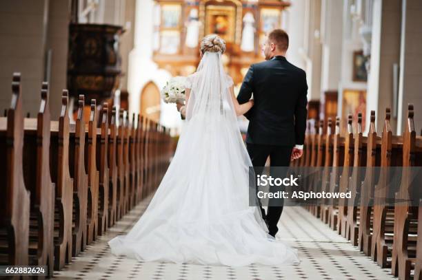 Photosession Of Stylish Wedding Couple On Catholic Church Stock Photo - Download Image Now