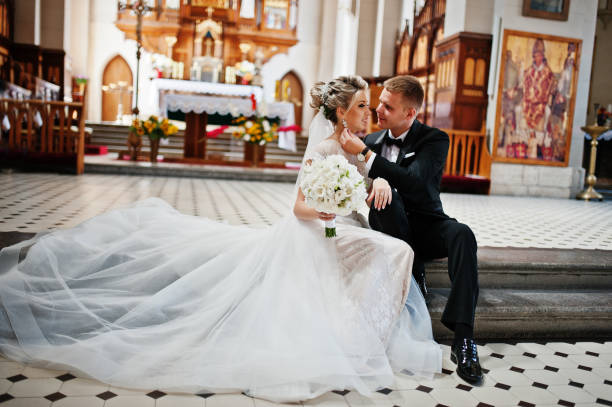 istock Wedding couple at catholic church 662882970
