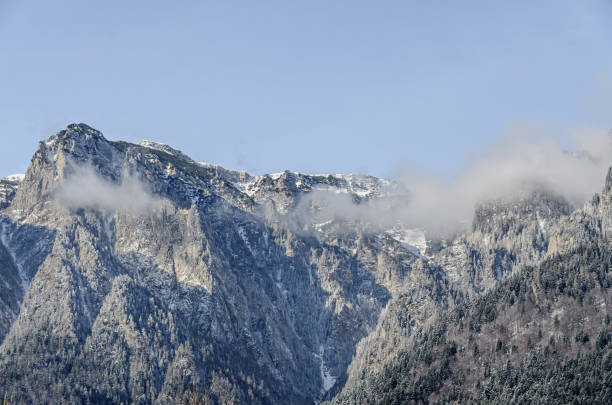 istock Romanian Carpathian mountains, Bucegi range with clouds, snow and fog, winter time landscape 662895374