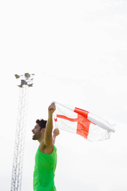 istock Athlete posing with england flag after victory 662909378