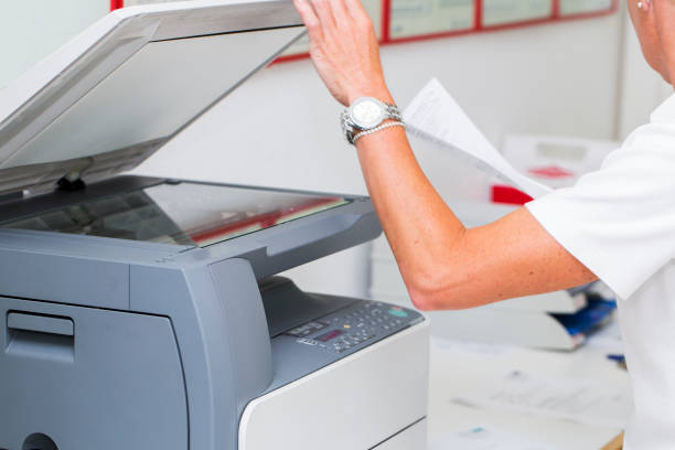 istock Nurse at work...using photocopier,copiing medical results 662914614