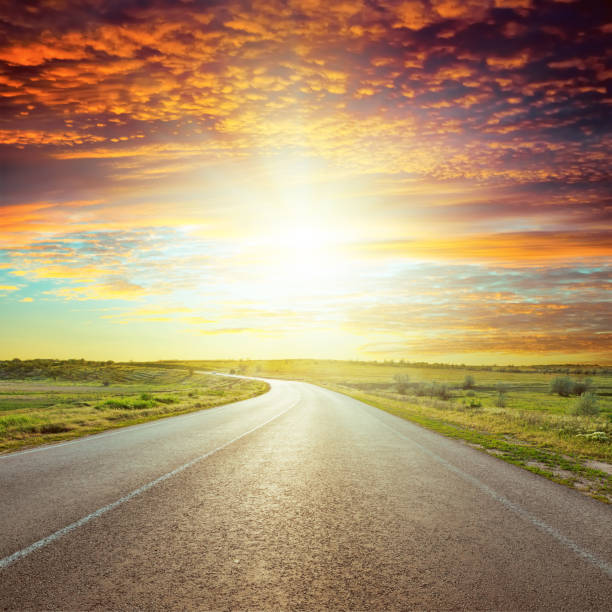 istock asphalt road to red horizon in sunset 662928848