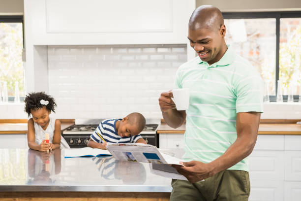 istock Father with coffee cup reading newspaper 662937522