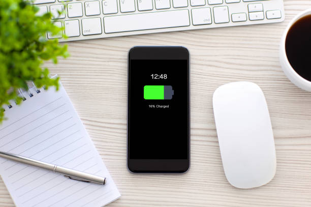 istock phone with charged battery screen on table in office 662944106