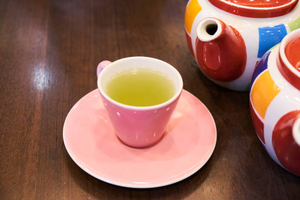 istock Green tea in a pink cup with teapot. 662948244