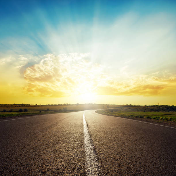 istock asphalt road to horizon and sunset in clouds 662948928