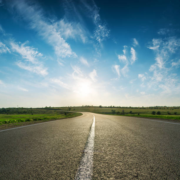 istock sunset in blue sky over asphalt road 662968698