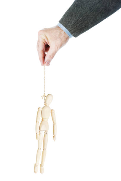 istock Male hand holds a rope with hanged man 662976642