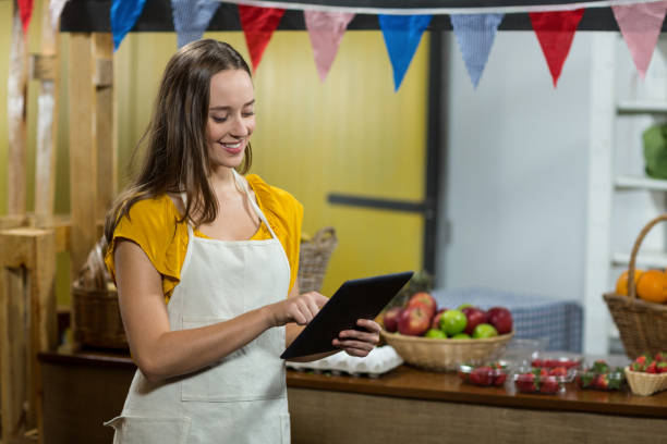 istock Woman vendor using digital tablet at the counter 662978556