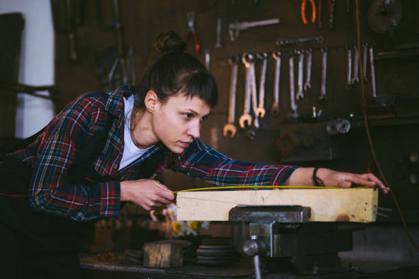 istock Focused Carpenter, Charming Woman Measuring Plank 662984350