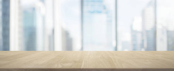 istock Wood table top and blur glass window wall building banner background 662984808