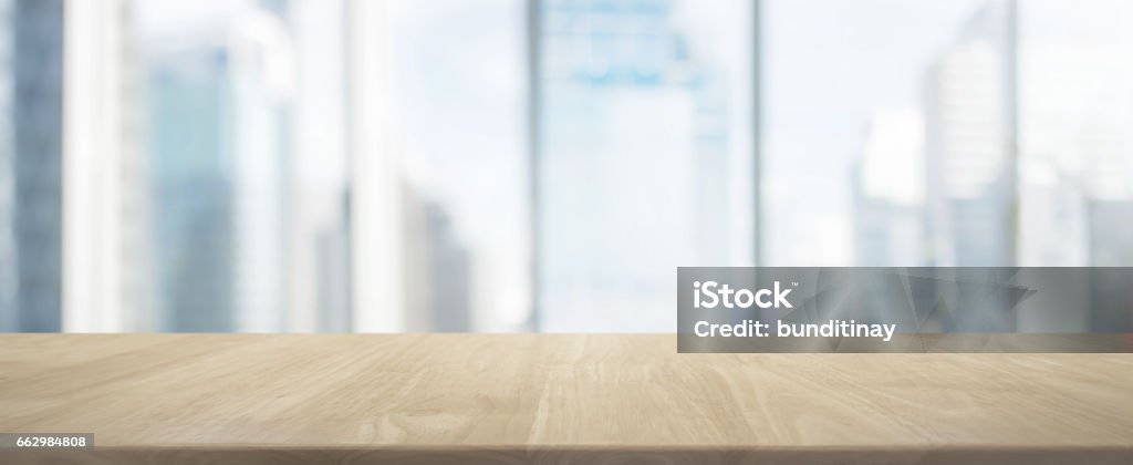 Wood table top and blur glass window wall building banner background Background - can used for display or montage your products. Office Stock Photo