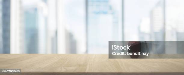 Wood Table Top And Blur Glass Window Wall Building Banner Background Stock Photo - Download Image Now