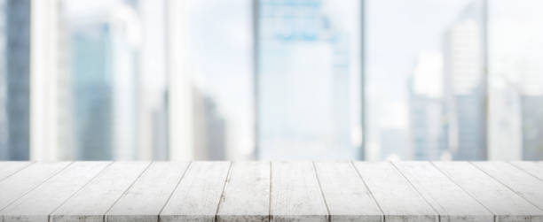 istock Wood table top and blur glass window wall building banner background 662984894