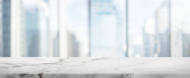 istock White Stone table top and blur glass window wall building banner background 662984906