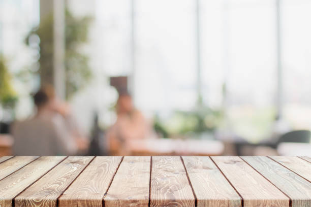 Wood table top and blurred restaurant interior background